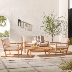 Walker Edison 4-Piece Modern Acacia Outdoor Slatted Chat Set With Coffee Table