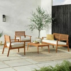 Walker Edison 4-Piece Mid-Century Modern Acacia Outdoor Slat-Back Chat Set With Coffee Table